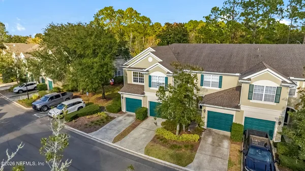 a aerial view of a house with a yard balcony and sitting area