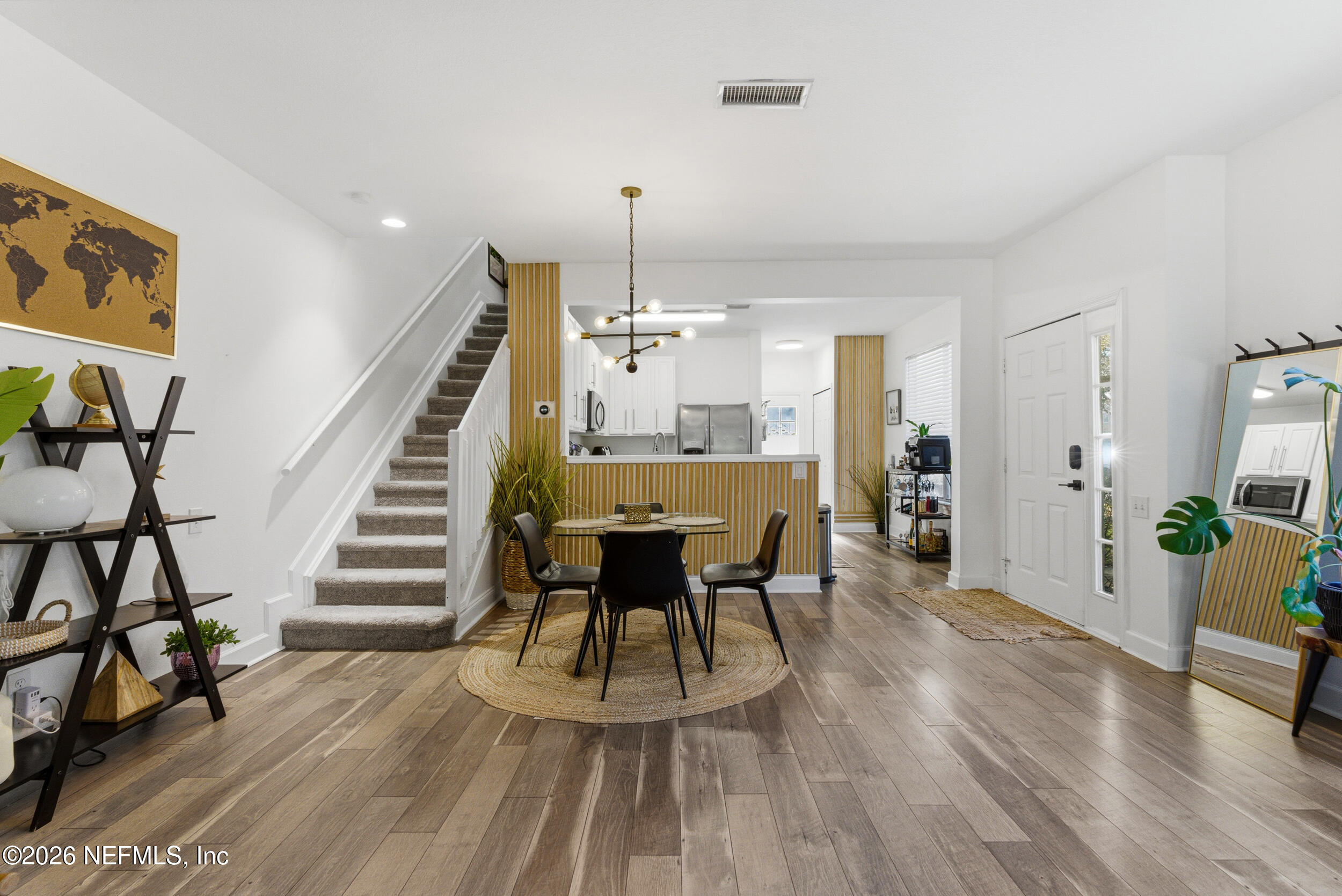 7990 Baymeadows Road, Unit 1801 Jacksonville, FL 32256 - Photo 9 of 48 a dining room with furniture a chandelier and wooden floor