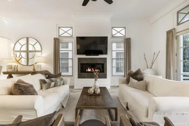 a living room with furniture a flat screen tv and a fireplace