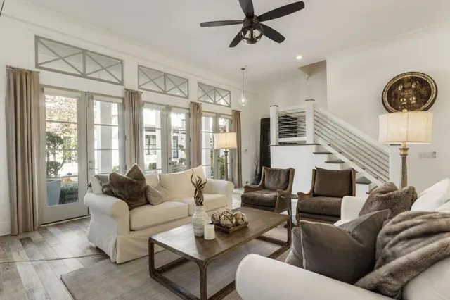 a view of a dining room and livingroom furniture wooden floor a chandelier