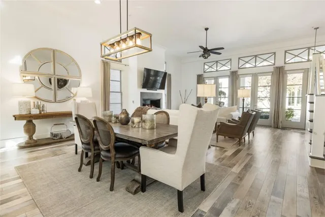 a living room with furniture a chandelier and fireplace