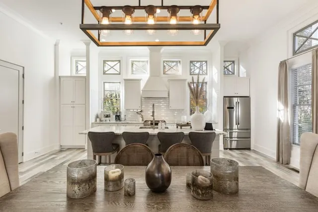 a view of a dining room with furniture and a chandelier