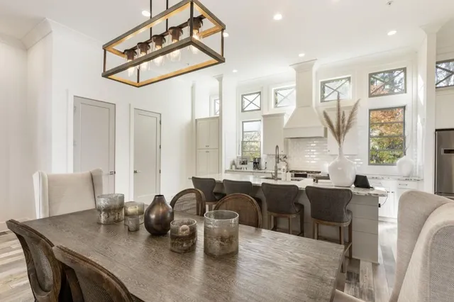 a kitchen with stainless steel appliances granite countertop a stove a sink and a granite counter tops with white cabinets