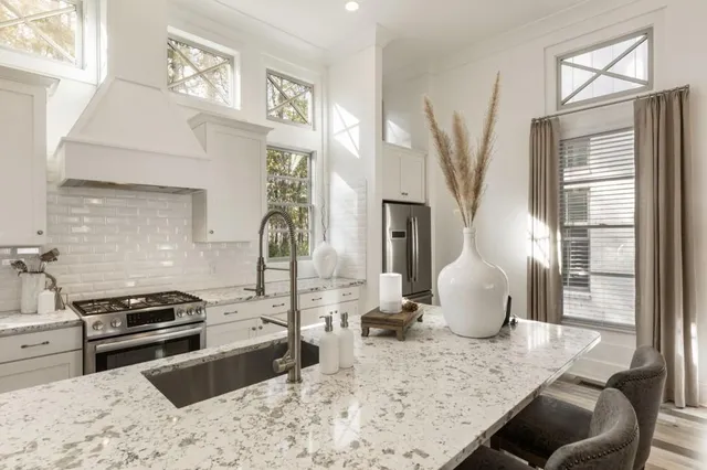 a kitchen with a sink stove and cabinets