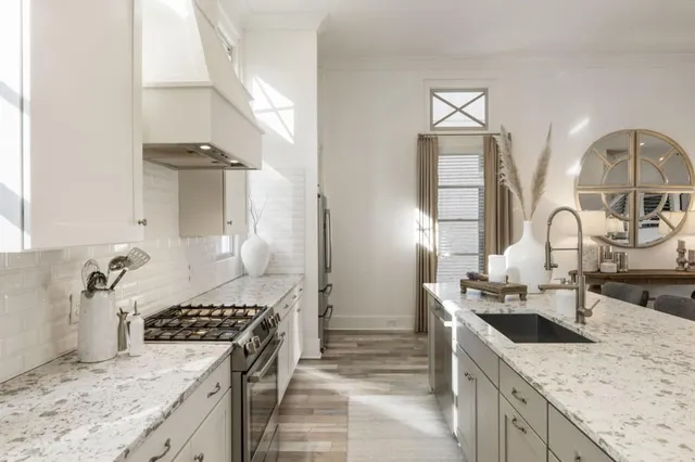 a view of a kitchen with kitchen island a large window a sink and living room view