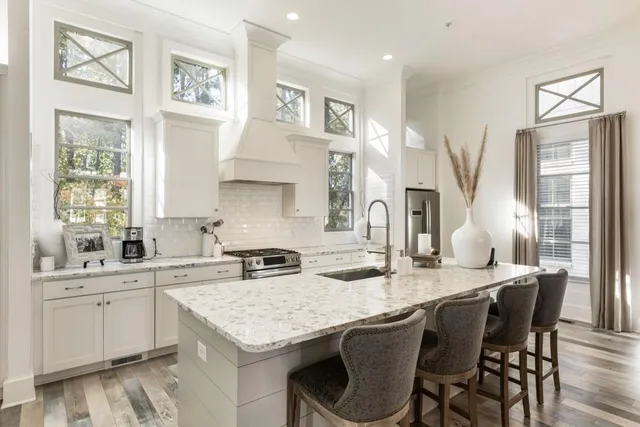 a kitchen with granite countertop a sink and cabinets