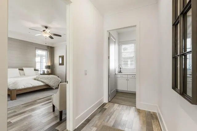 a spacious bedroom with a bed and large windows