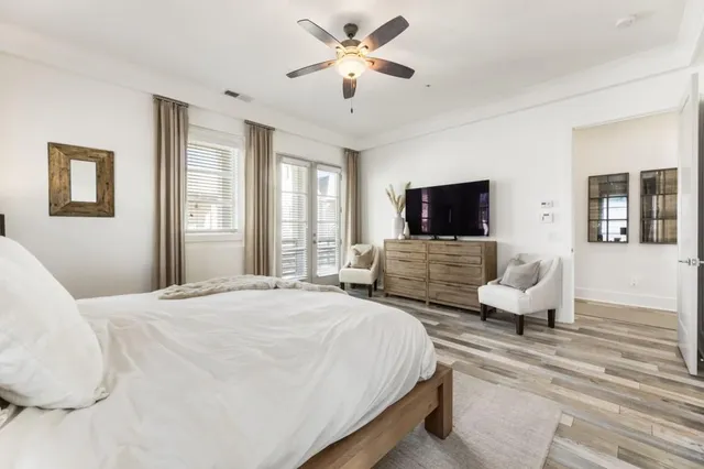 a spacious bedroom with a bed and a large window