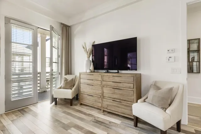 a balcony with wooden floor and furniture