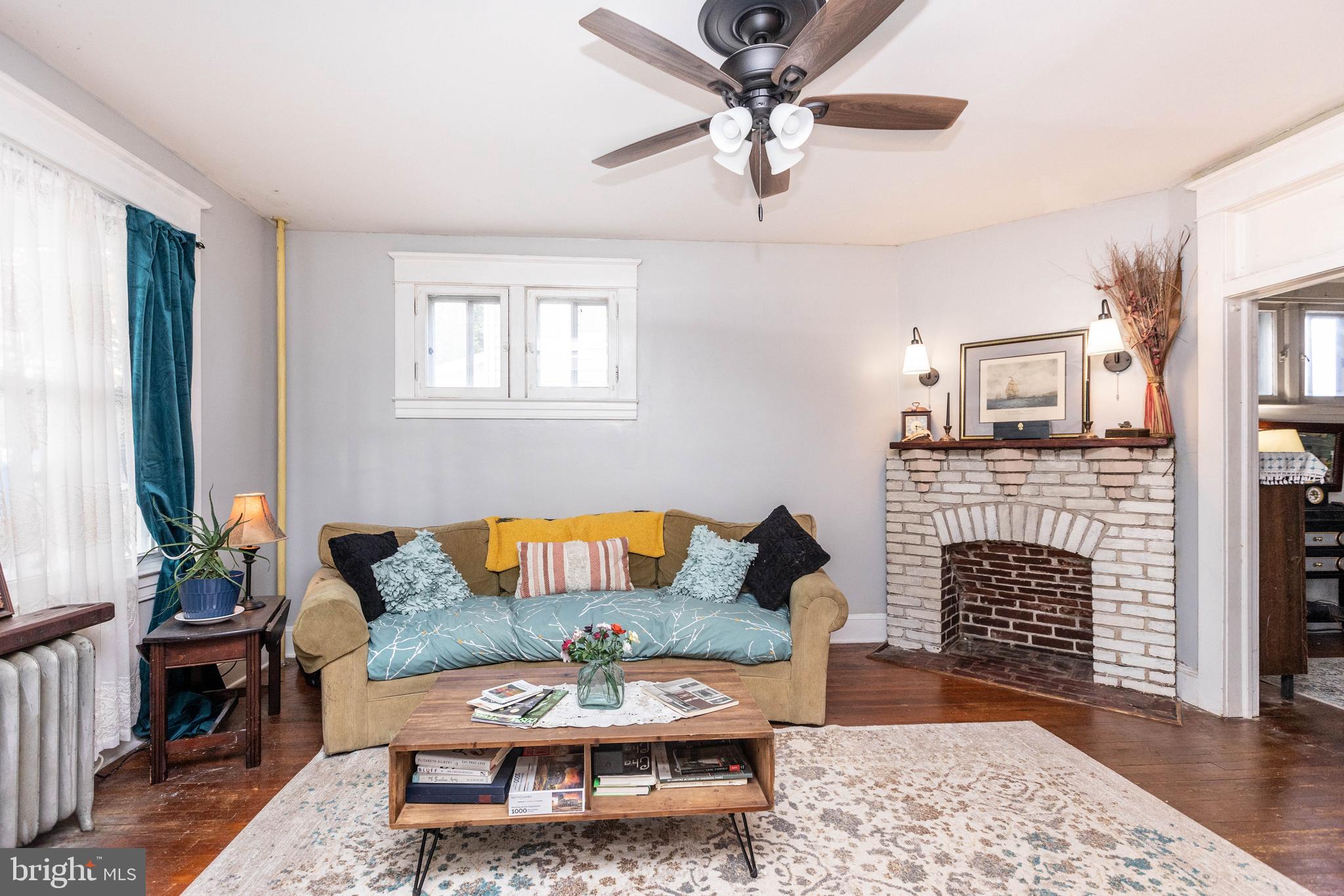 4223 Harcourt Road Baltimore, MD 21214 - Photo 6 of 36 Living Room with fireplace and ceiling fan.