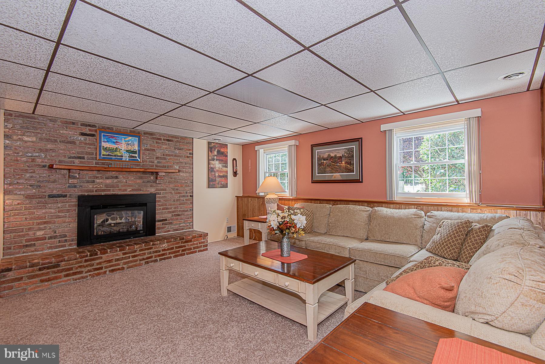 8309 Risha Drive Severn, MD 21144 - Photo 27 of 34 Gas fireplace in basement recreation room