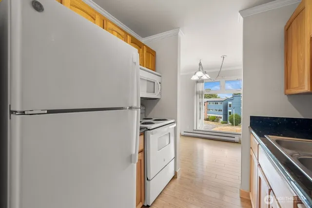 a kitchen with stainless steel appliances granite countertop a refrigerator and a sink