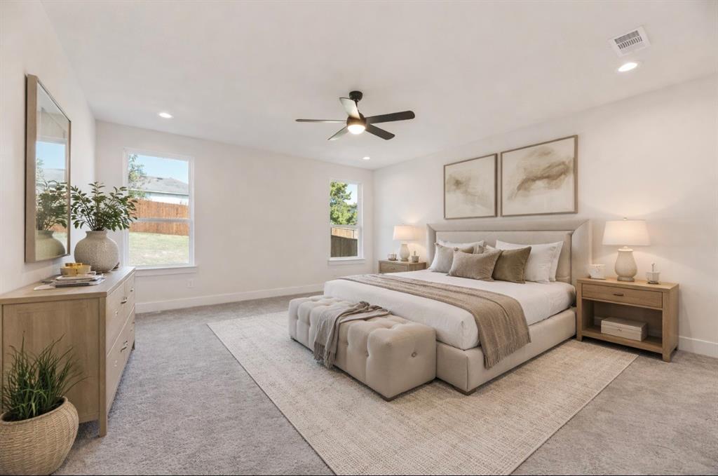 6046 Plum Dale Road Dallas, TX 75241 - Photo 13 of 27 a spacious bedroom with a bed and a chandelier
