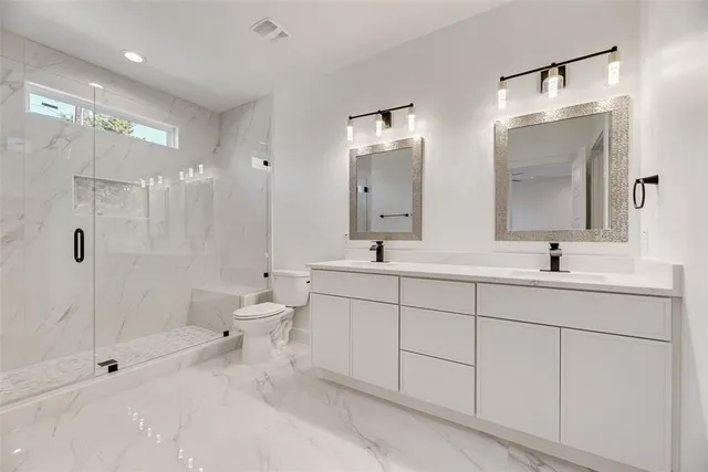 a spacious bathroom with double sink and a mirror
