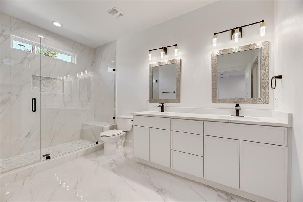 6046 Plum Dale Road Dallas, TX 75241 - Photo 14 of 27 a spacious bathroom with double sink and a mirror