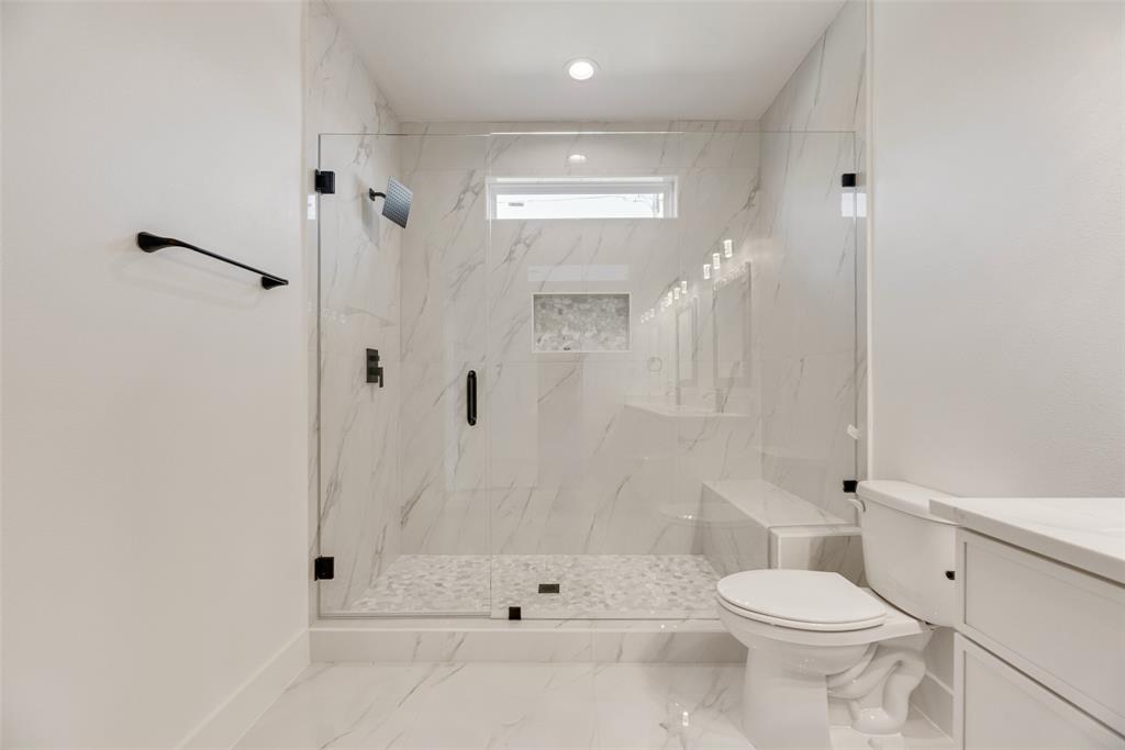 6046 Plum Dale Road Dallas, TX 75241 - Photo 15 of 27 a bathroom with a toilet sink and shower