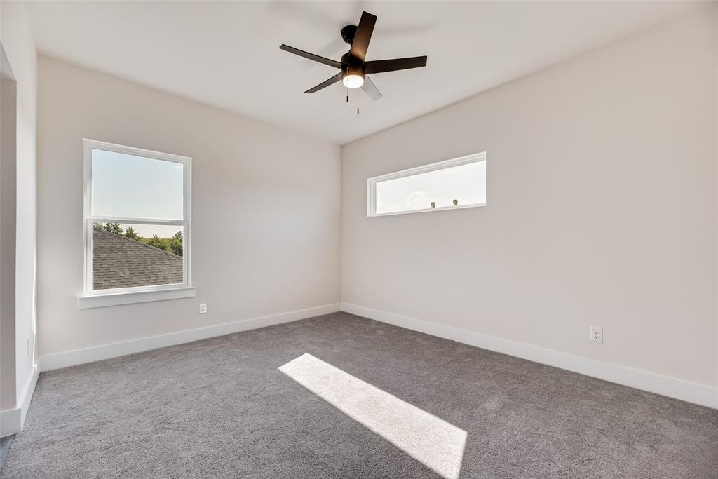 6046 Plum Dale Road Dallas, TX 75241 - Photo 21 of 27 an empty room with a window and a fan