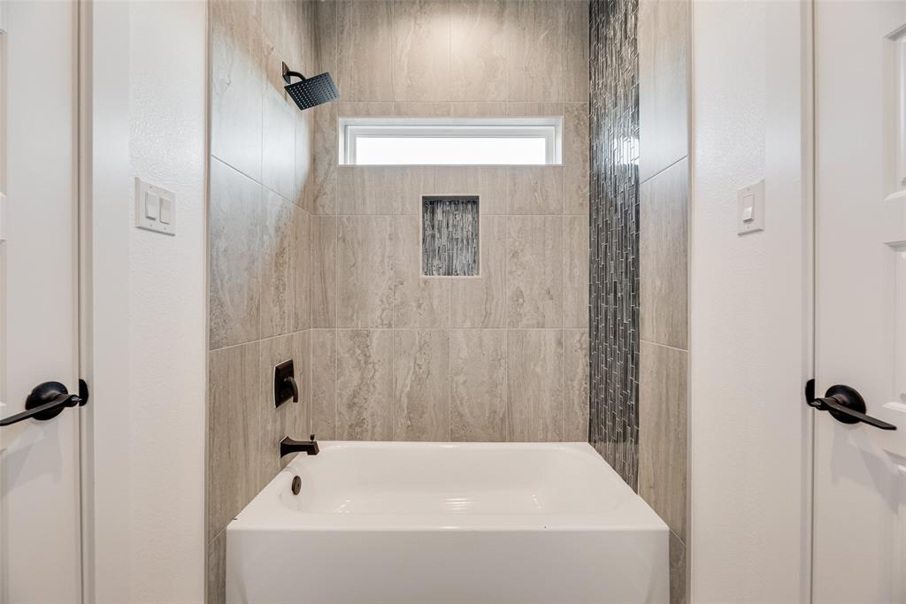 6046 Plum Dale Road Dallas, TX 75241 - Photo 23 of 27 a bathroom with a bathtub
