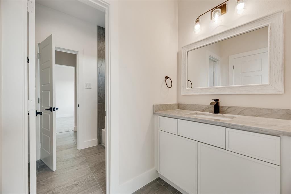 6046 Plum Dale Road Dallas, TX 75241 - Photo 24 of 27 a bathroom with a sink and a mirror