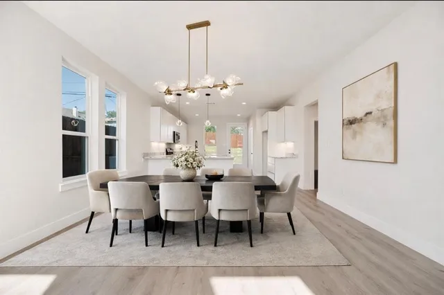 a view of a dining room with furniture and chandelier