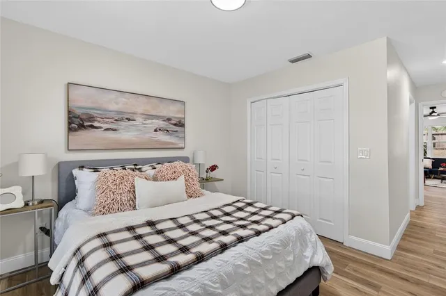 a bedroom with a bed and a painting on the wall