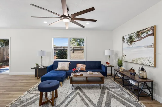 a living room with furniture and wooden floor