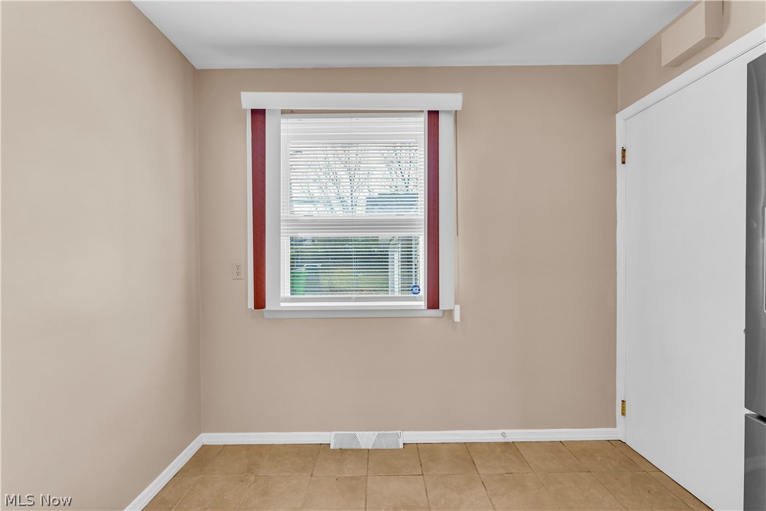 9716 Alexander Road Cleveland, OH 44125 - Photo 16 of 30 Unfurnished room featuring baseboards and light tile patterned flooring