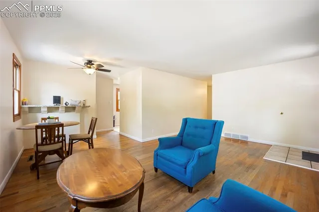 a living room with furniture rug and wooden floor