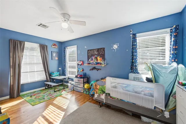 a bedroom with a bed and a large window