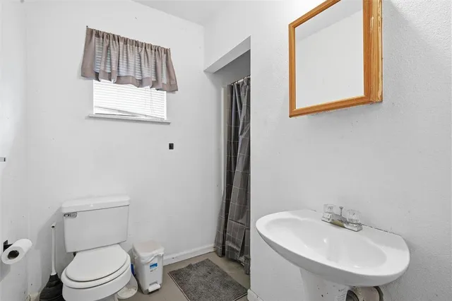 a bathroom with a sink a mirror and a toilet