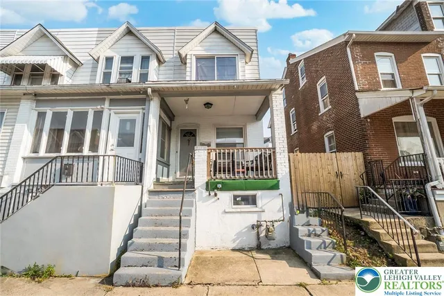 a view of a brick house with many windows