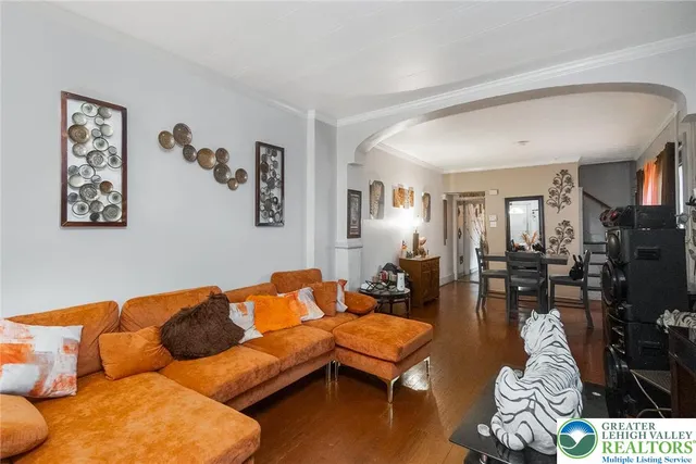 a living room with furniture a couch and a window