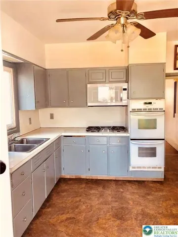 a kitchen with a stove cabinets and a sink