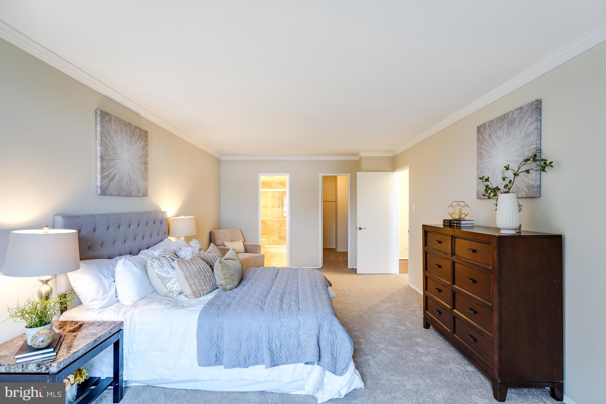 1800 Old Meadow Road, Unit 621 McLean, VA 22102 - Photo 11 of 28 a spacious bedroom with a bed and furniture