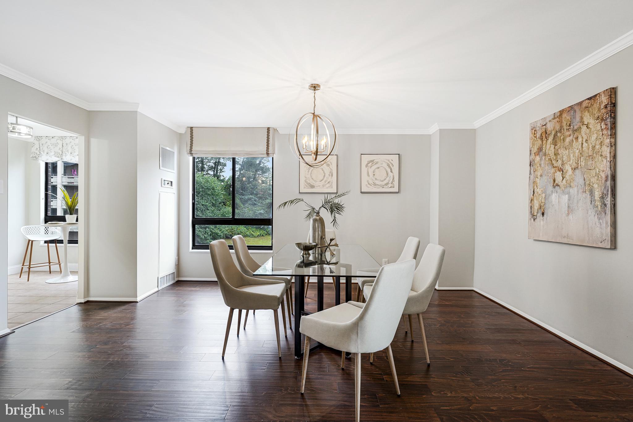 1800 Old Meadow Road, Unit 621 McLean, VA 22102 - Photo 6 of 28 a view of a dining room with furniture window and wooden floor