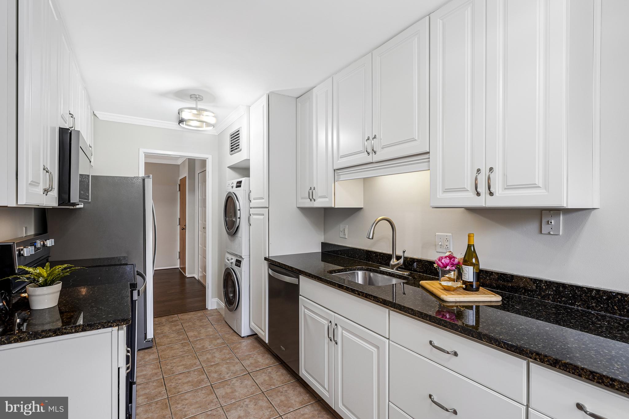 1800 Old Meadow Road, Unit 621 McLean, VA 22102 - Photo 9 of 28 a kitchen with stainless steel appliances granite countertop a refrigerator sink and cabinets