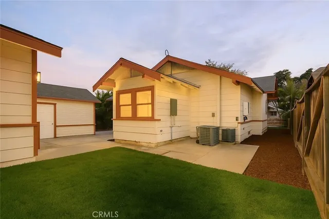 a view of a house with backyard and porch