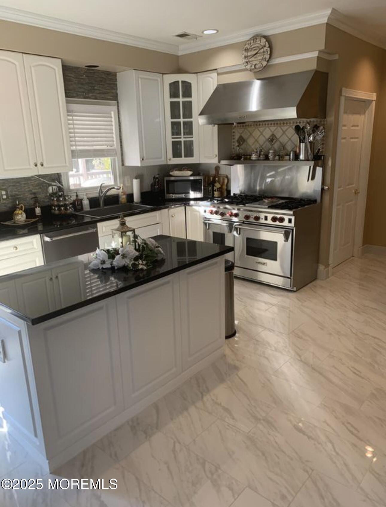 41 Church Road Howell, NJ 07731 - Photo 16 of 69 a kitchen with stainless steel appliances granite countertop a stove a sink and a microwave