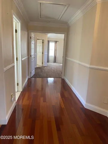 a living room with furniture and a refrigerator