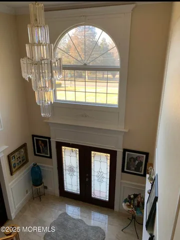 a view of a dining room with furniture and chandelier