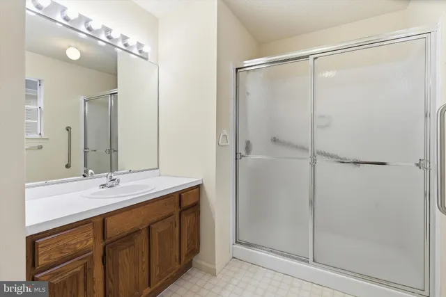a bathroom that has a glass shower door