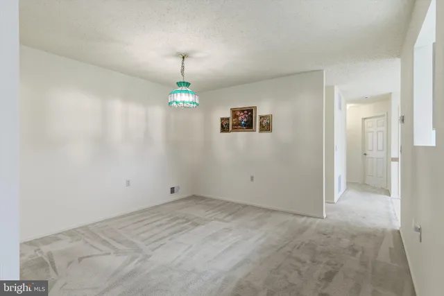 a view of an empty room with a fireplace