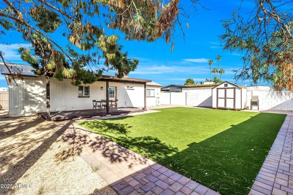 a view of a house with a backyard