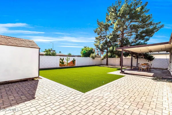 a view of a patio with a table and chairs
