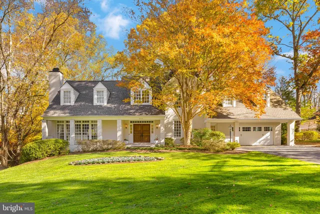 a front view of a house with a yard table and chairs