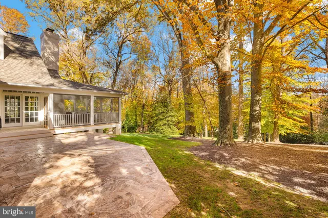front view of a house with a yard and trees