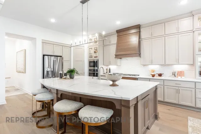 a kitchen with a table chairs stove and refrigerator
