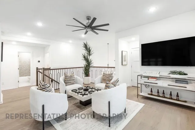 a view of a livingroom with furniture and a large window