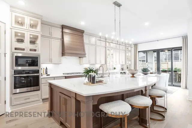 a kitchen with a dining table chairs and white cabinets