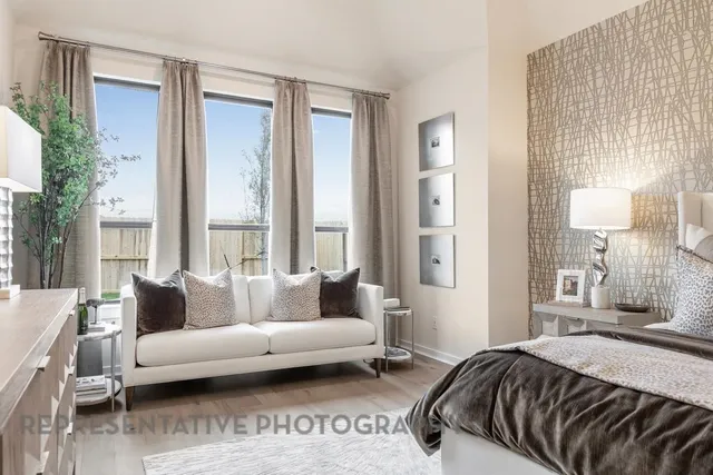 a spacious bedroom with a bed and a chandelier